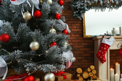 Beautiful decorated Christmas tree in festive room interior