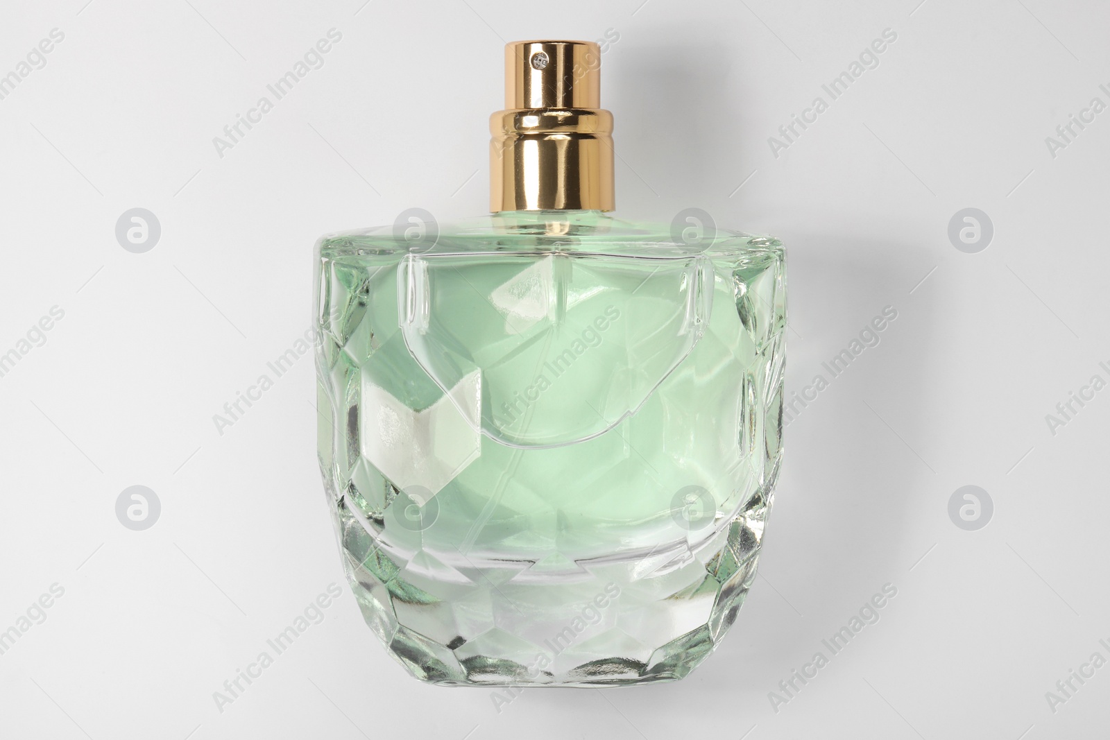 Photo of Luxury women's perfume in bottle on white background, top view