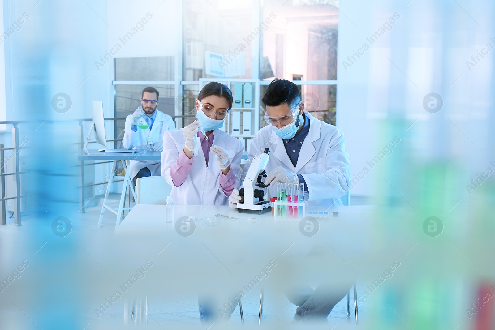 Photo of Young scientists working in laboratory. Chemical analysis