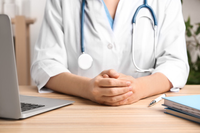 Photo of Doctor at table in office, closeup. Medical service