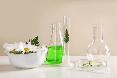 Ingredients and laboratory glassware on table. Dermatology research