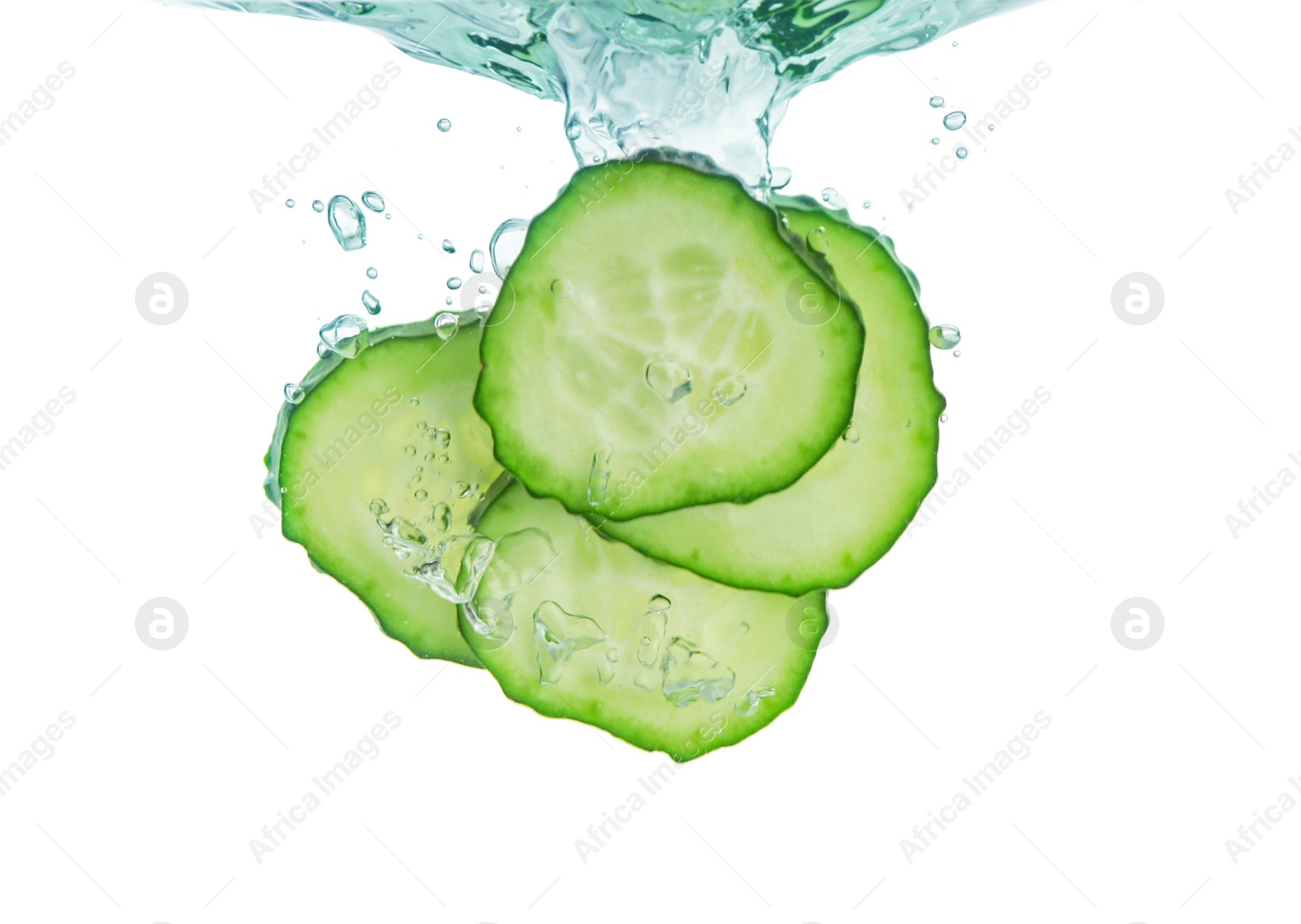 Photo of Fresh cucumber slices in water on white background