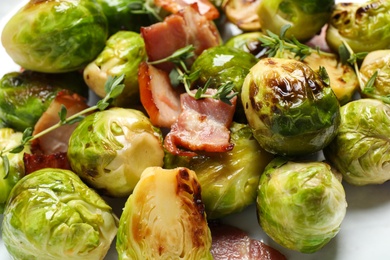 Photo of Closeup view of delicious Brussels sprouts with bacon