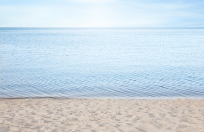 Sandy beach near sea on sunny summer day