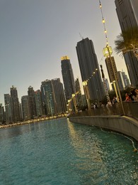 Dubai, United Arab Emirates - May 2, 2023: Beautiful modern buildings near embankment in city