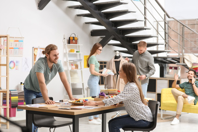 Fashion designers creating new clothes in studio