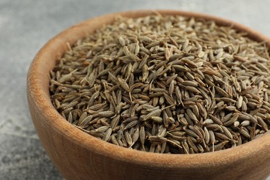 Photo of Bowl of caraway seeds on table, closeup