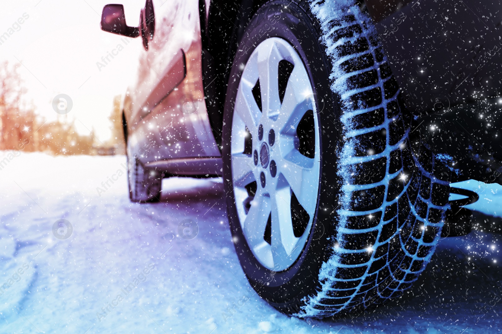 Image of Car with winter tires on snowy road, closeup view