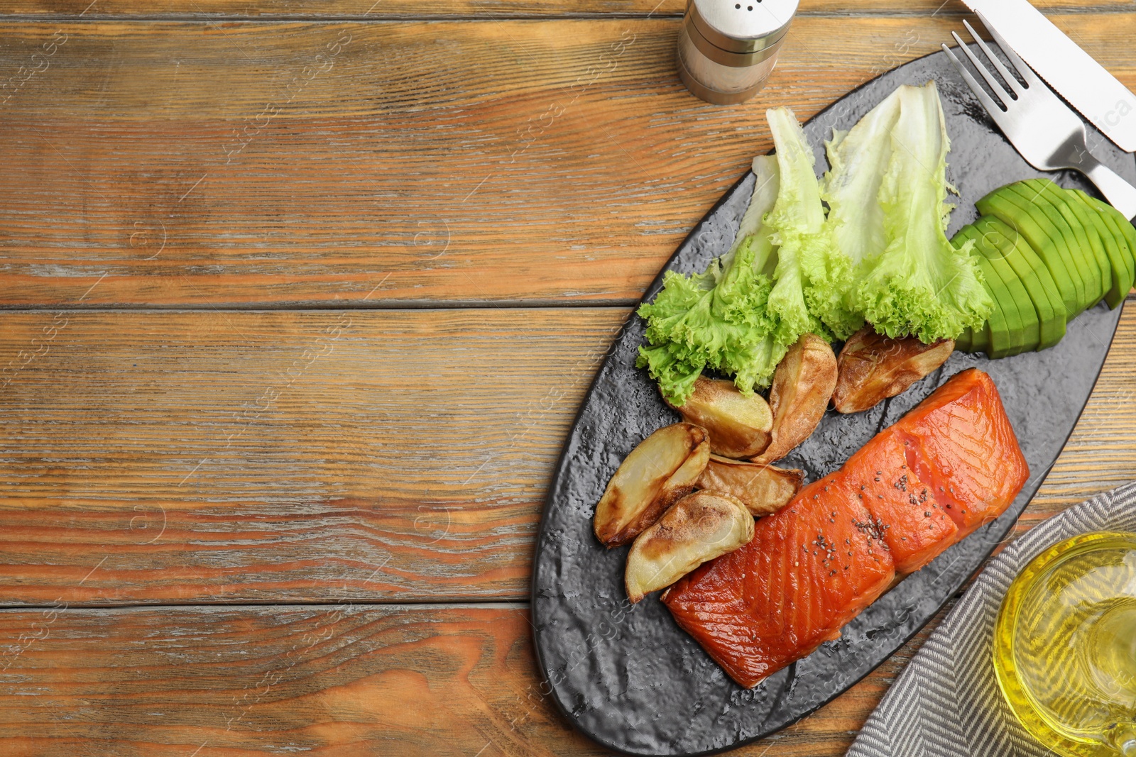 Photo of Tasty cooked salmon and vegetables served on wooden table, flat lay with space for text. Healthy meals from air fryer