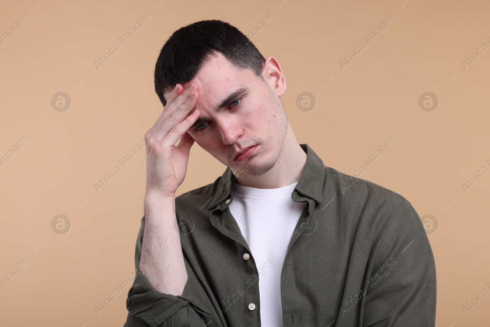 Photo of Portrait of sad man on beige background