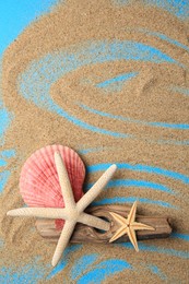 Piece of wood with beautiful starfishes and sand on blue background, flat lay. Space for text
