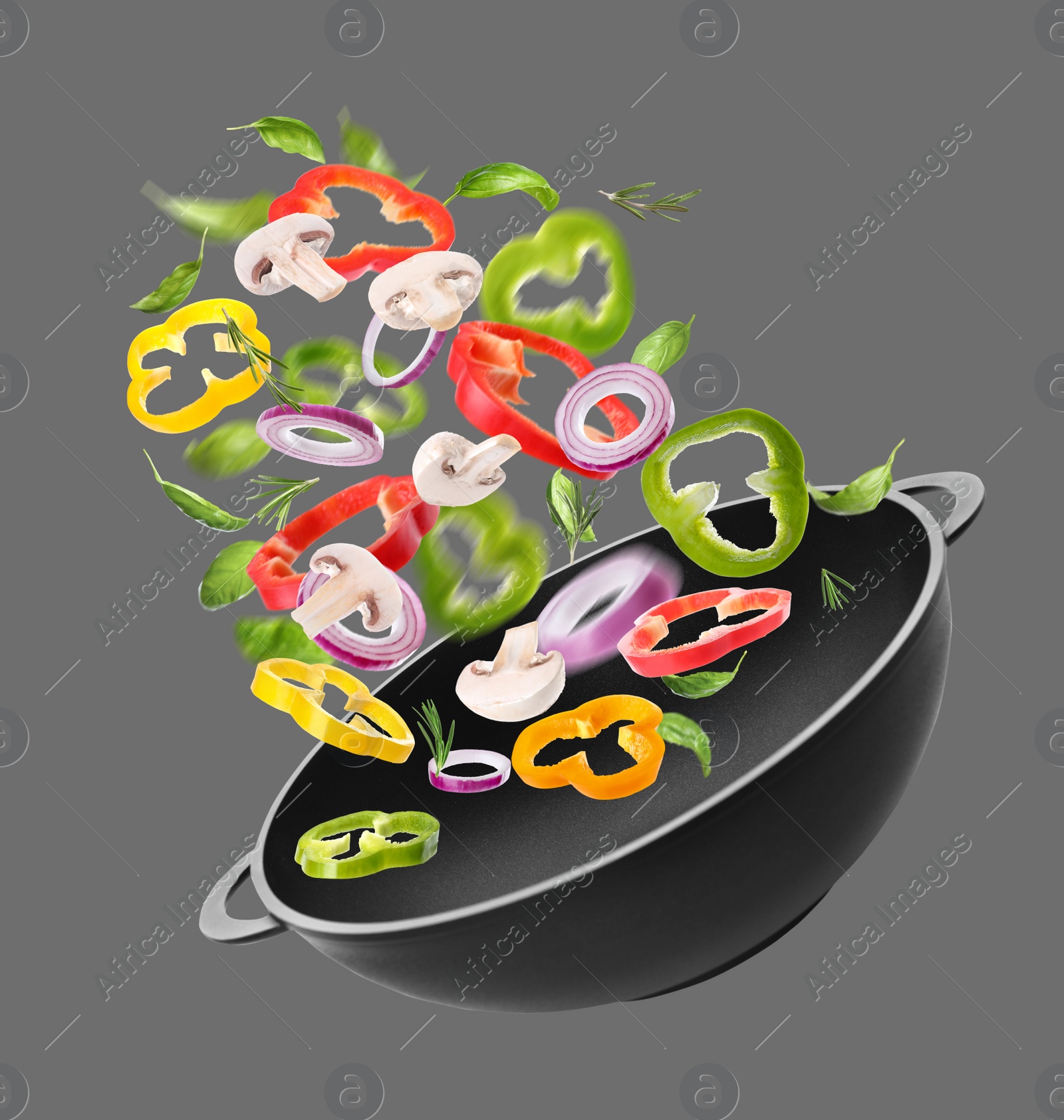 Image of Different tasty ingredients falling into wok on light grey background