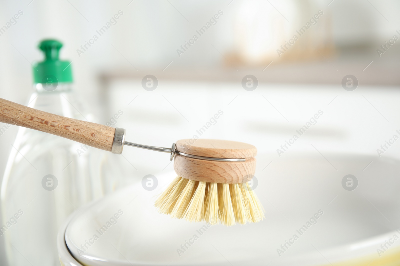 Photo of Cleaning brush for dish washing indoors, closeup