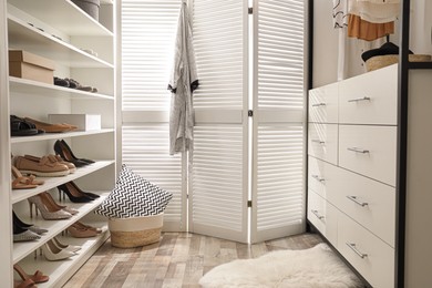 Dressing room interior with storage rack for shoes and accessories