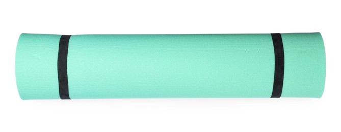 Photo of Turquoise rolled camping or exercise mat on white background, top view
