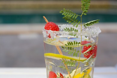 Delicious refreshing lemonade with raspberries outdoors, closeup. Space for text