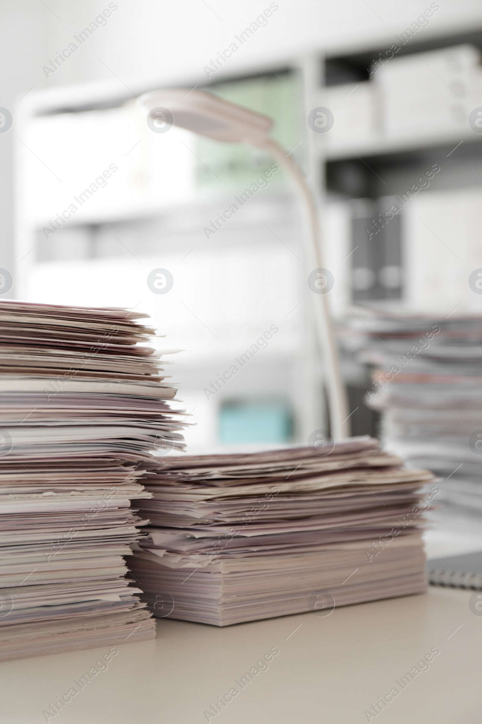 Photo of Stacks of documents on desk in office. Space for text