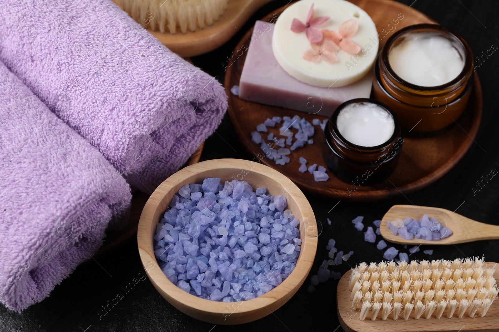 Photo of Composition with different spa products and lavender on black table, closeup