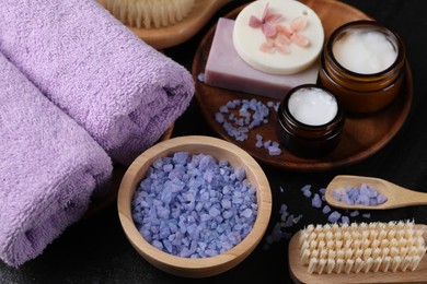 Photo of Composition with different spa products and lavender on black table, closeup