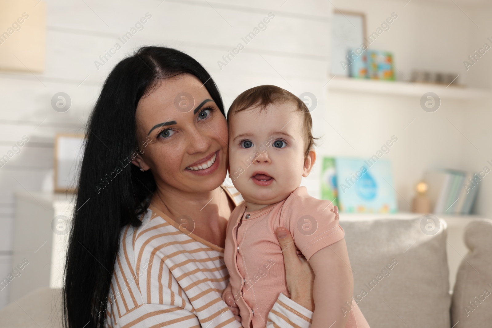 Photo of Happy mother with her cute baby at home