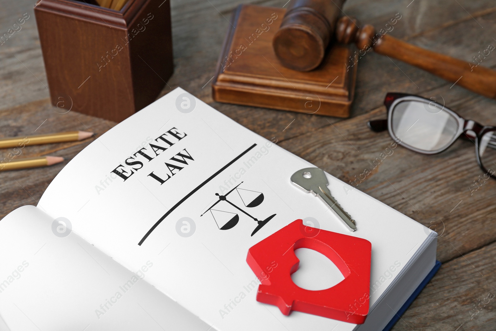 Photo of Composition with book, gavel and house key on wooden background. Estate law concept