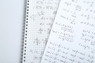 Photo of Sheets of paper with different mathematical formulas on white table, top view