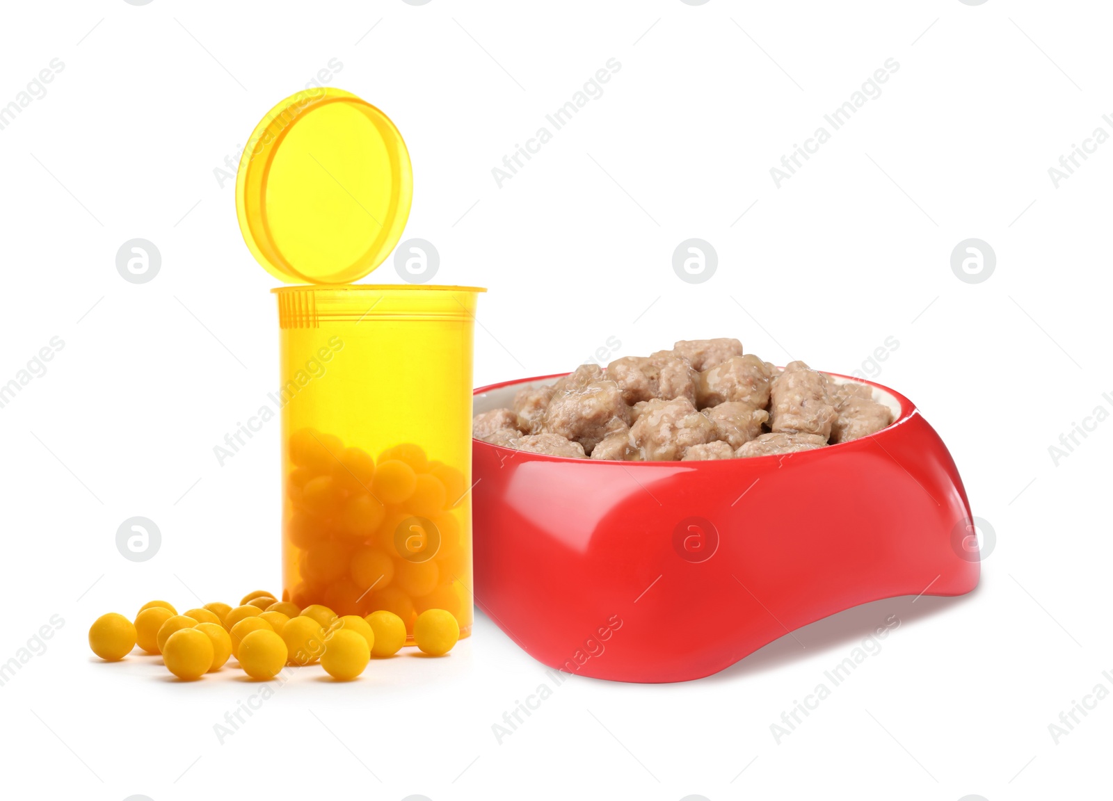 Image of Wet pet food in feeding bowl and vitamin pills on white background