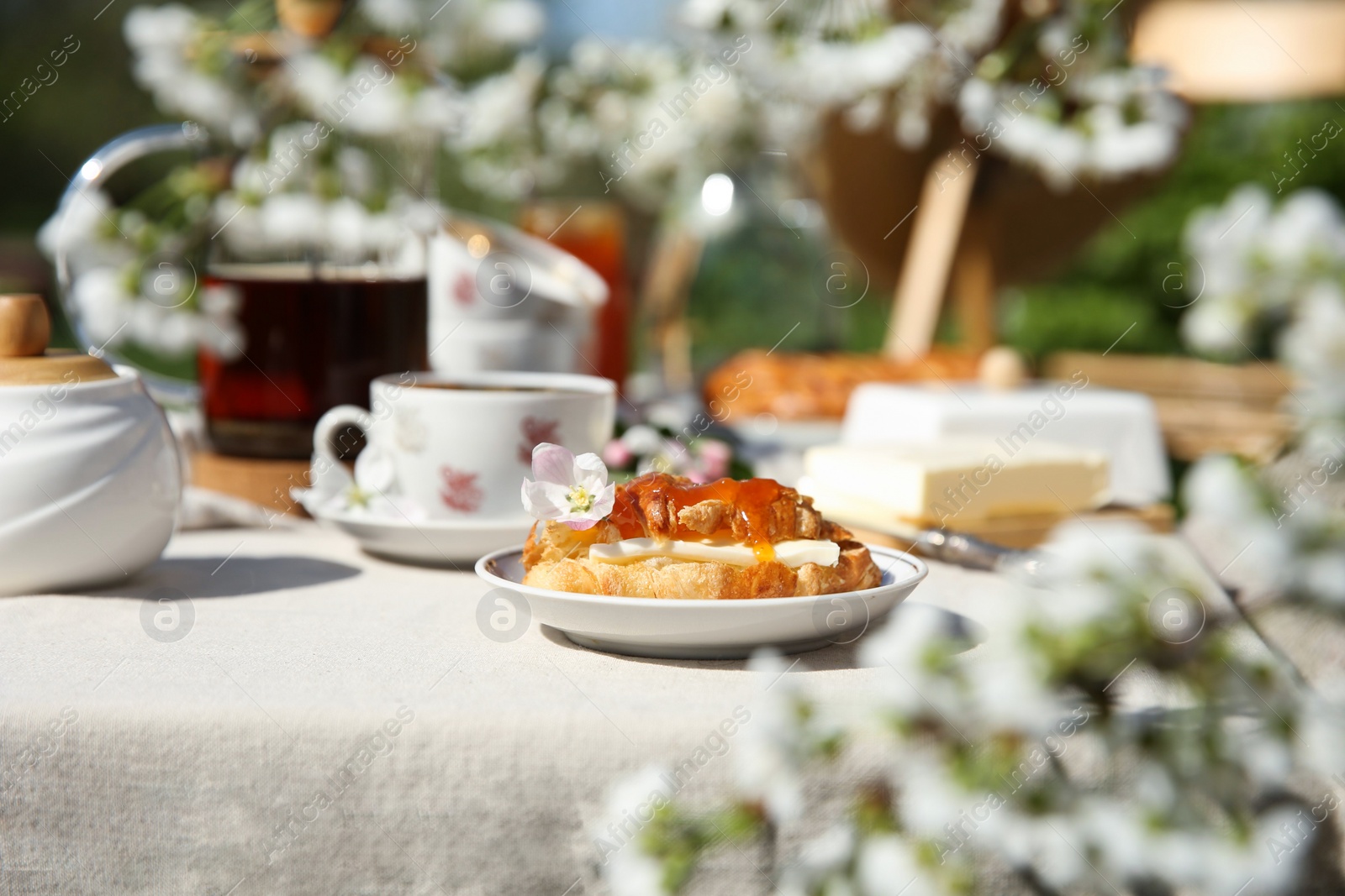 Photo of Beautiful table setting in spring garden on sunny day