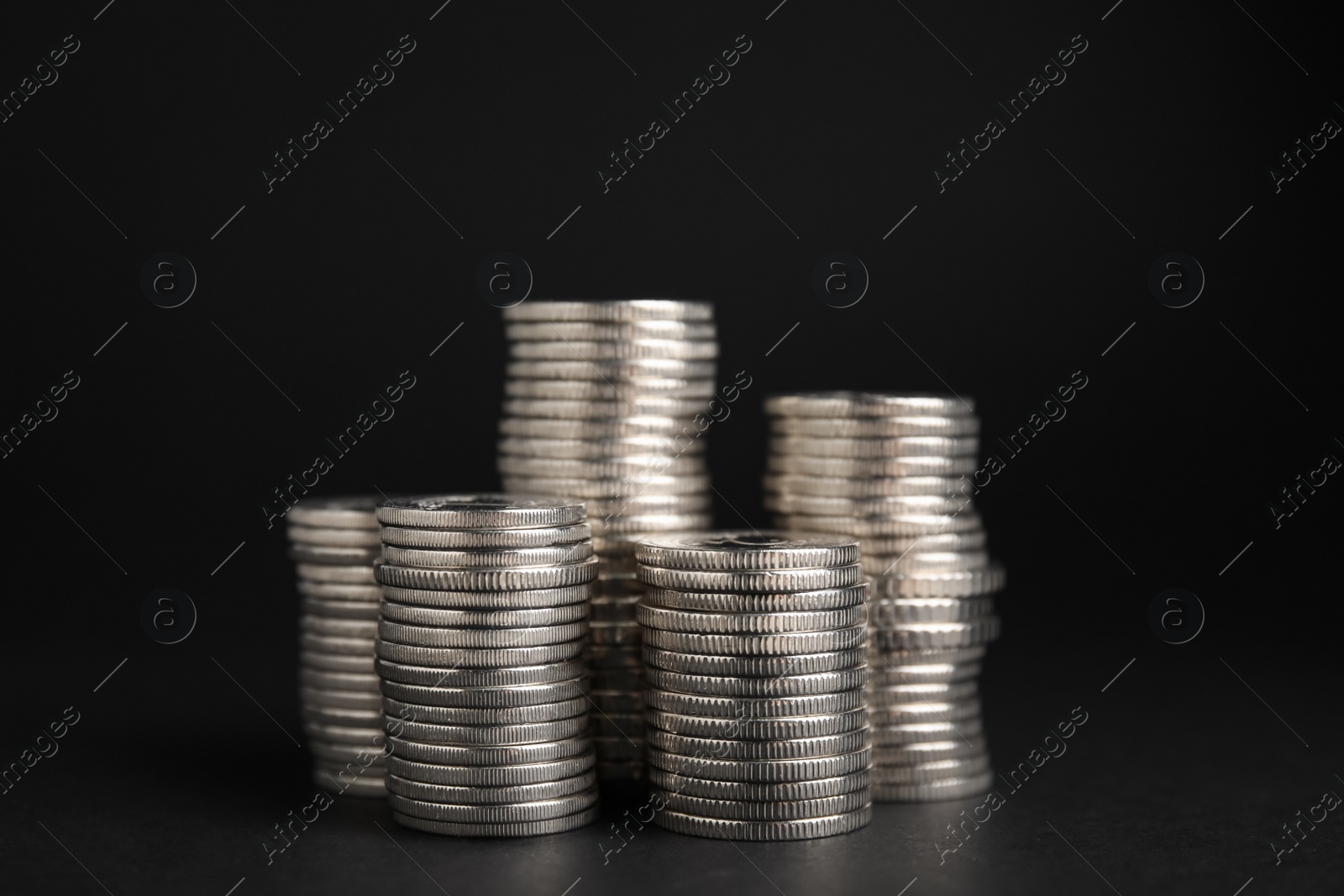 Photo of Many Euro coins stacked on black background