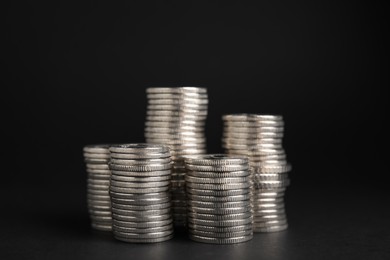 Photo of Many Euro coins stacked on black background