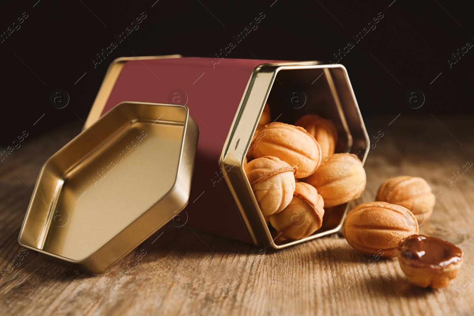 Photo of Homemade walnut shaped cookies with boiled condensed milk on wooden table