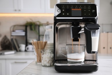 Photo of Modern coffee machine making tasty drink in office kitchen, space for text