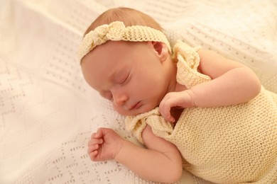 Photo of Adorable newborn baby sleeping on knitted plaid