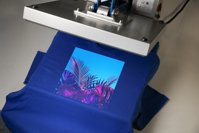 Image of Custom t-shirt. Using heat press to print image of bright tropical leaves