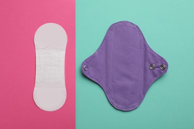 Photo of Pantyliner and reusable menstrual pad on color background, flat lay