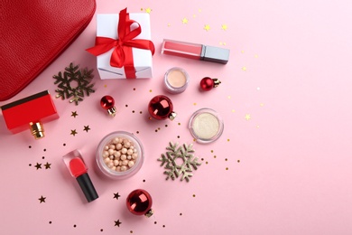 Photo of Flat lay composition with decorative cosmetic products on pink background. Winter care