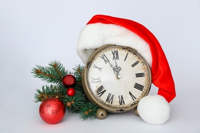 Photo of Vintage alarm clock with Christmas decor on white background. New Year countdown