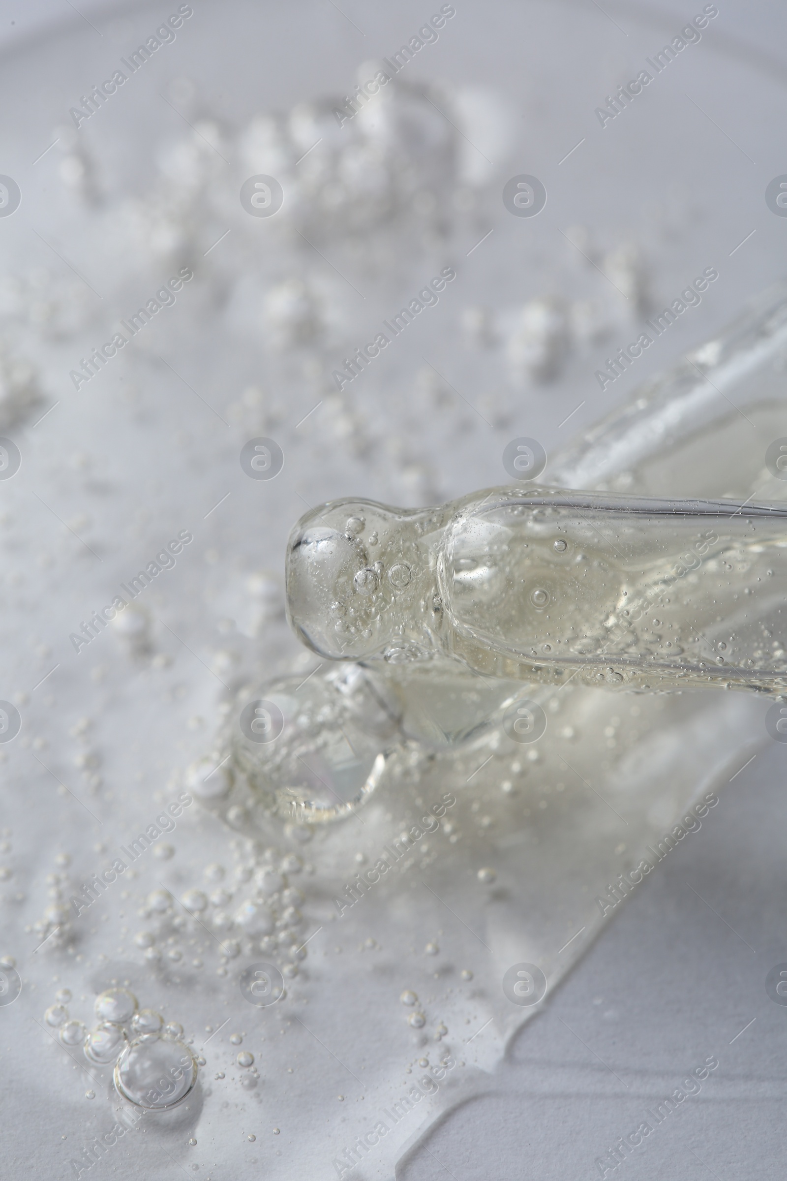 Photo of Pipettes with cosmetic serum on white background, macro view