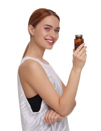 Photo of Happy young woman with bottle of pills on white background. Weight loss