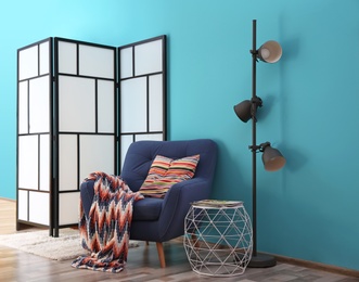 Photo of Modern bright interior with comfortable blue armchair