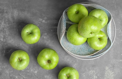 Photo of Composition with fresh green apples on grey table, top view