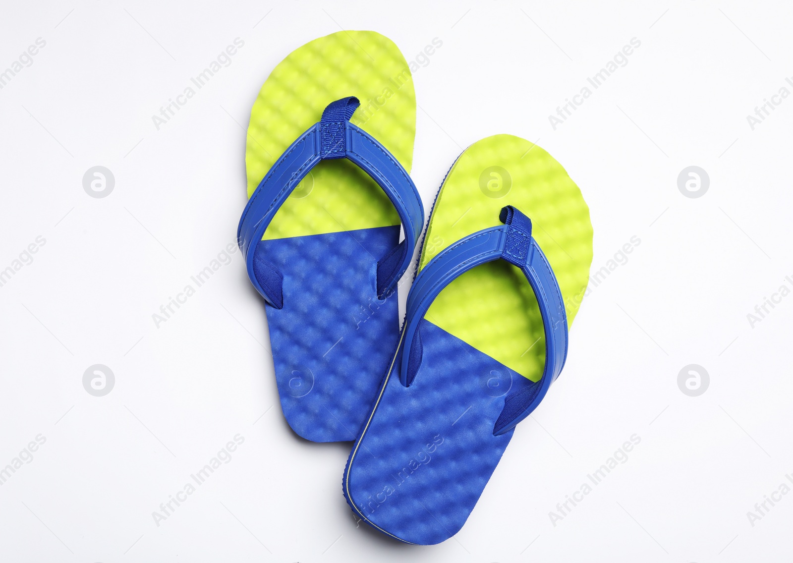 Photo of Pair of flip flops on white background, top view. Beach accessories