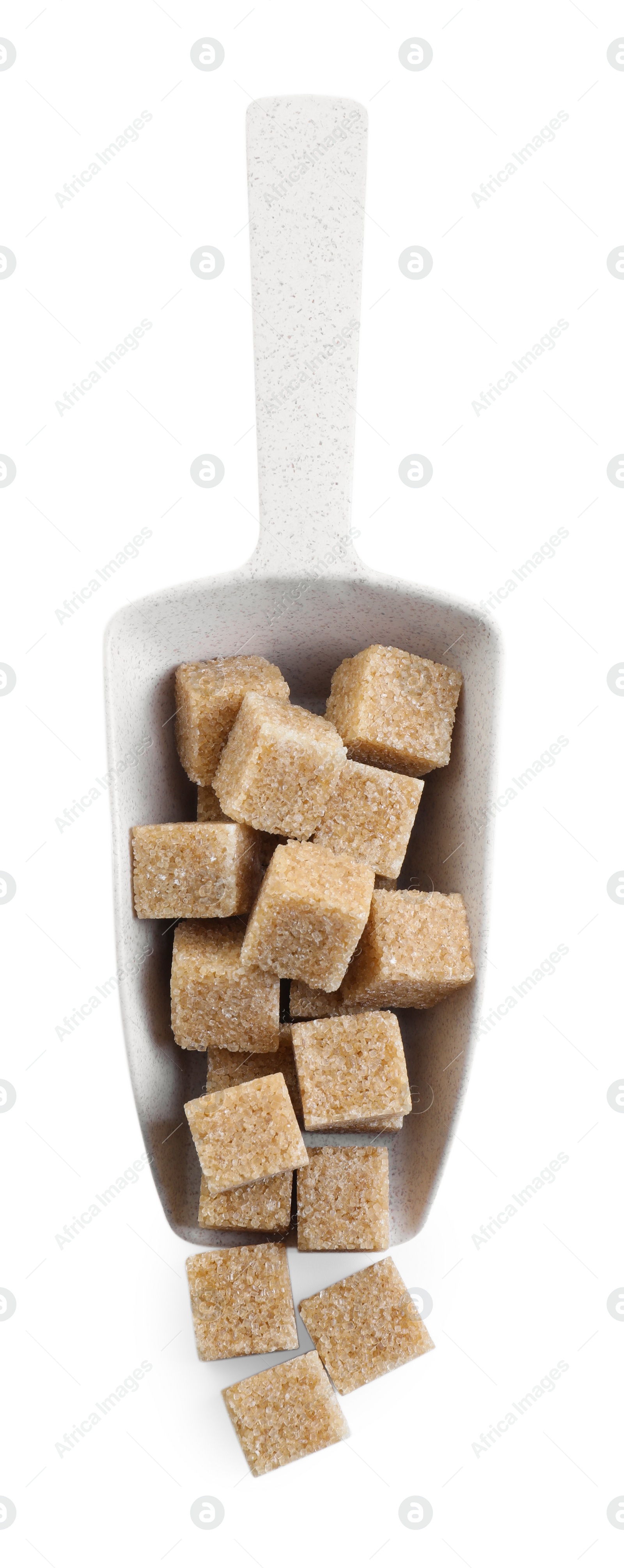 Photo of Brown sugar cubes in scoop isolated on white, top view