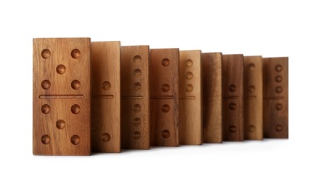 Photo of Row of wooden domino tiles on white background