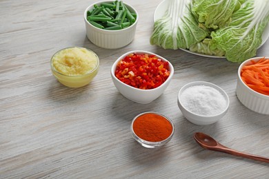 Photo of Fresh Chinese cabbages and other ingredients for kimchi on wooden table