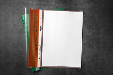 File folders with punched pockets on grey table, flat lay. Space for text