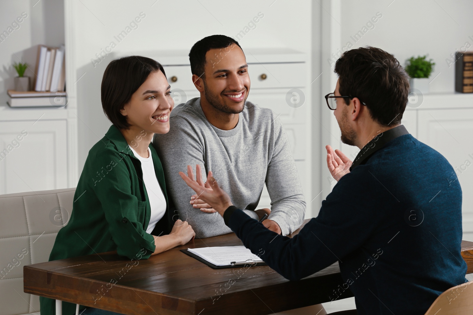 Photo of Professional notary working with couple in office