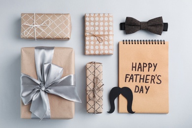 Photo of Flat lay composition with bow tie and gift boxes on gray background. Happy Father's Day