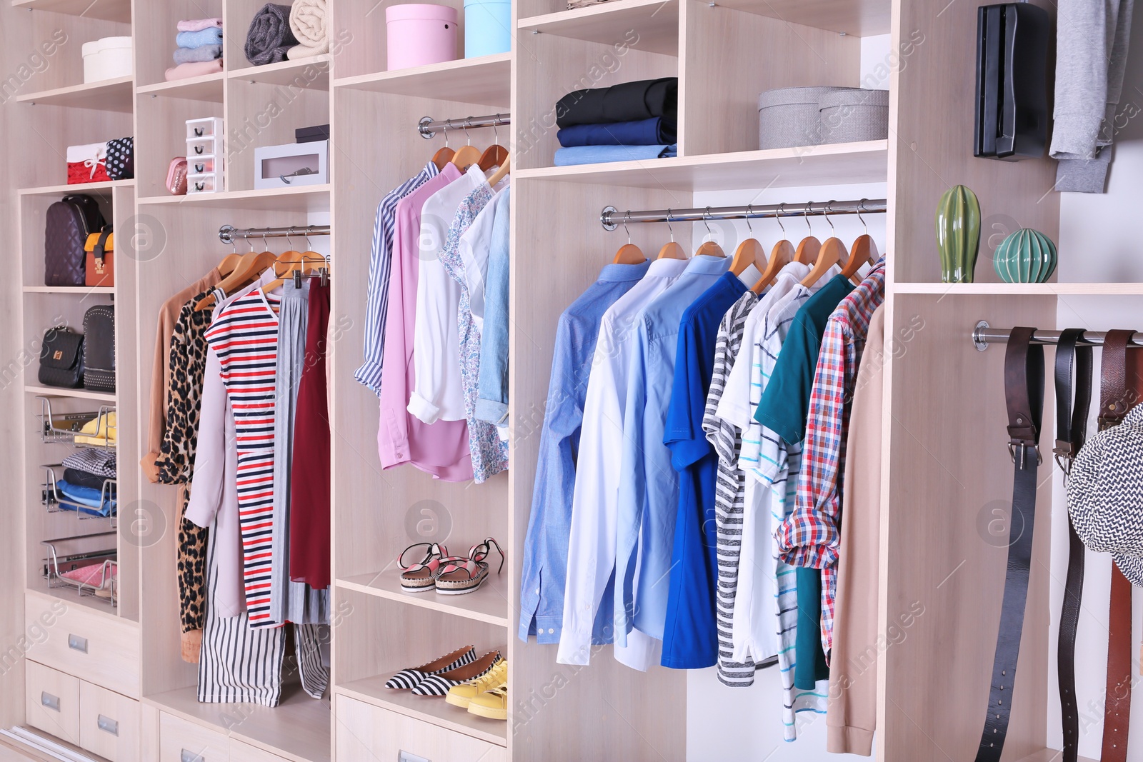 Photo of Large wardrobe with different clothes and shoes