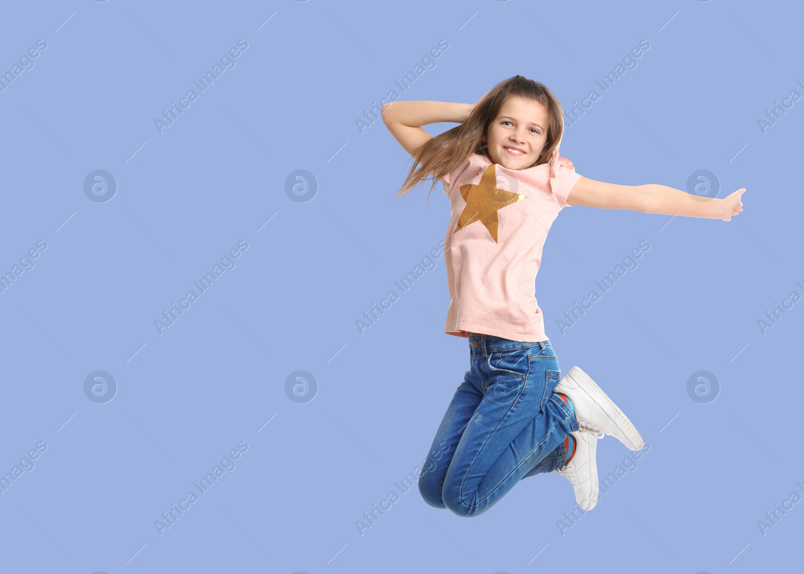 Image of Cute girl jumping on light blue background, space for text